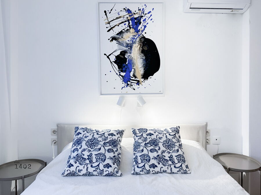Bedroom with blue patterned cushions