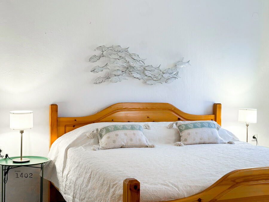 Bedroom with double bed and wooden furniture
