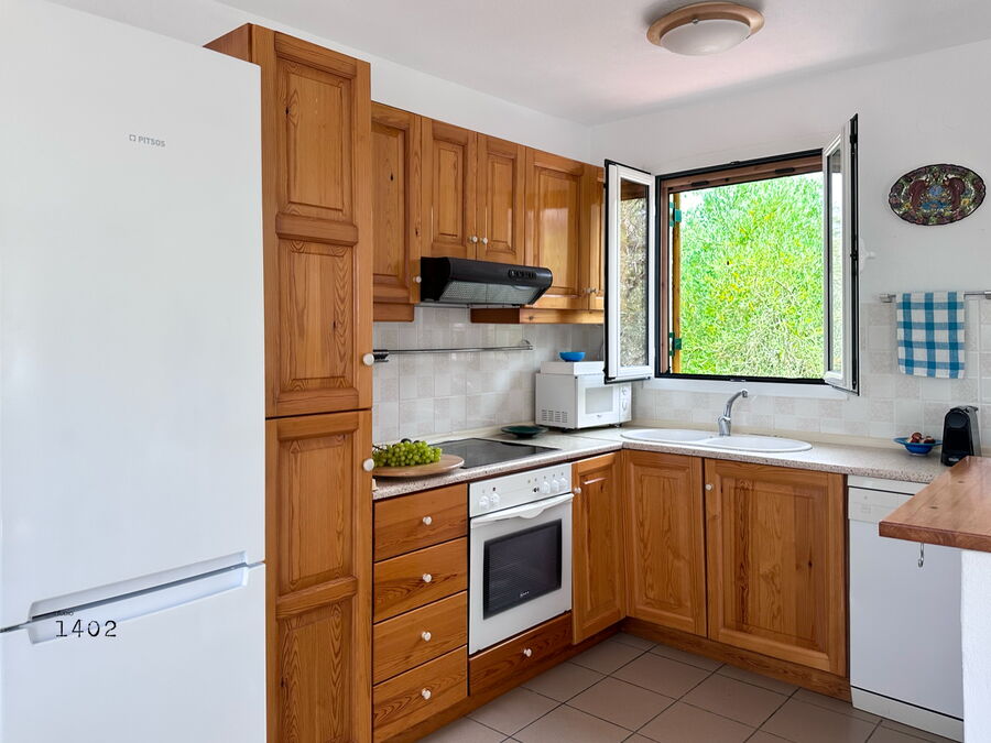 Kitchen with wooden fronts and window